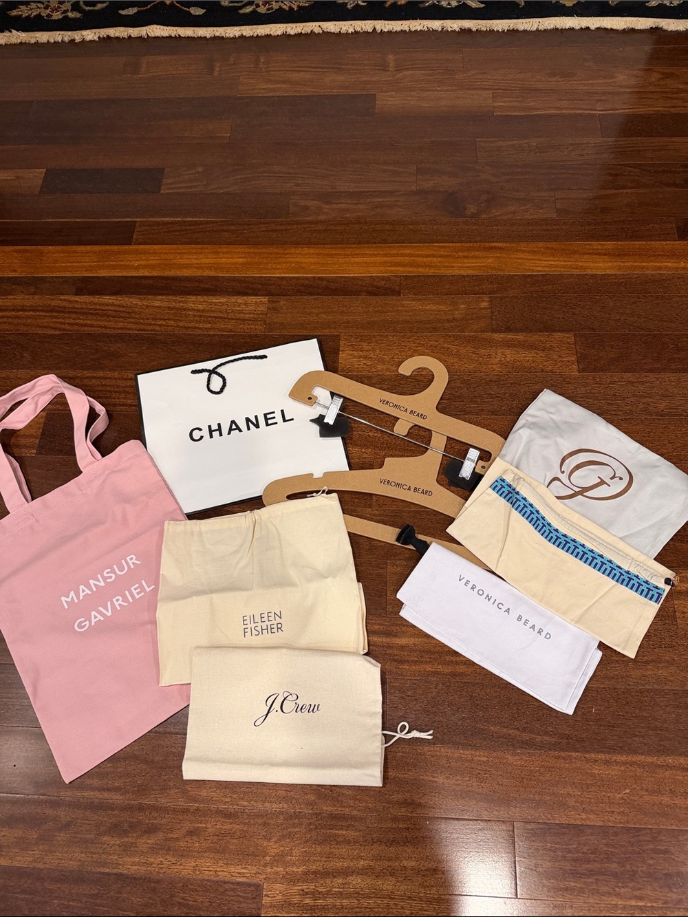 Veronica Beard  hangers, Chanel gift bag, and various dust bags